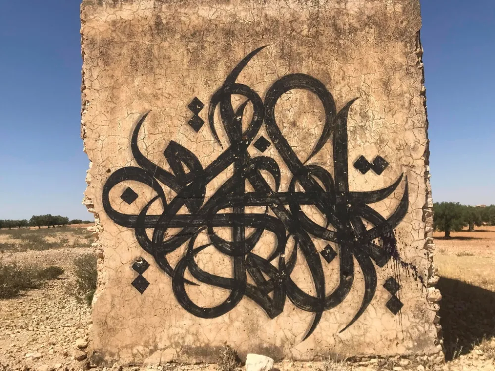 Arabic calligraphy carved in stone, showing the distinctive cursive script of the Arabic language